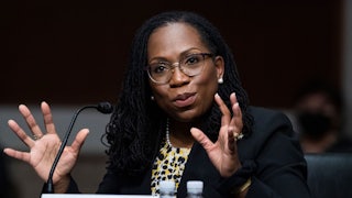 A close up of Ketanji Brown Jackson as she speaks during a confirmation hearing.