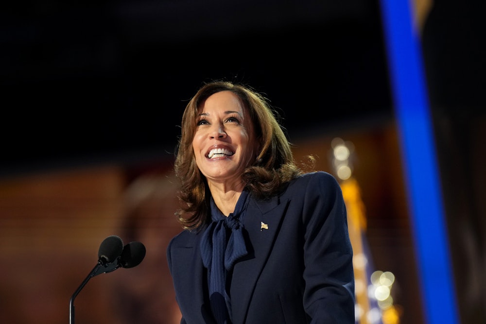 Kamala Harris smiles on stage