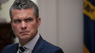 Defense Secretary Pete Hegseth looks to the side
