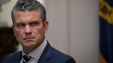 Defense Secretary Pete Hegseth looks to the side