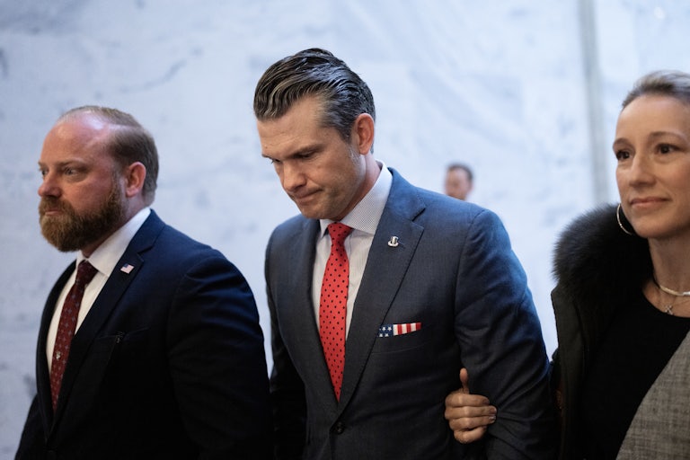 Pete Hegseth looks down while walking in the Senate