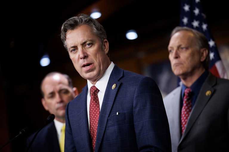 Representative Andy Ogles speaks at a lectern. Two other Republican representatives stand behind him.