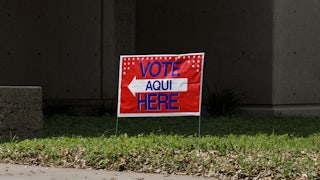 A sign outside a polling station that says, "Vote Aqui/Here"