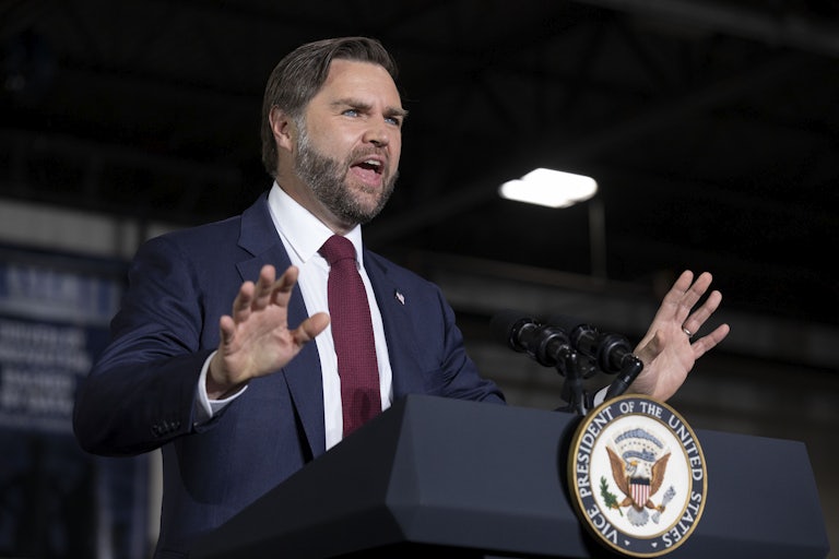 Vice President JD gestures while speaking at a podium