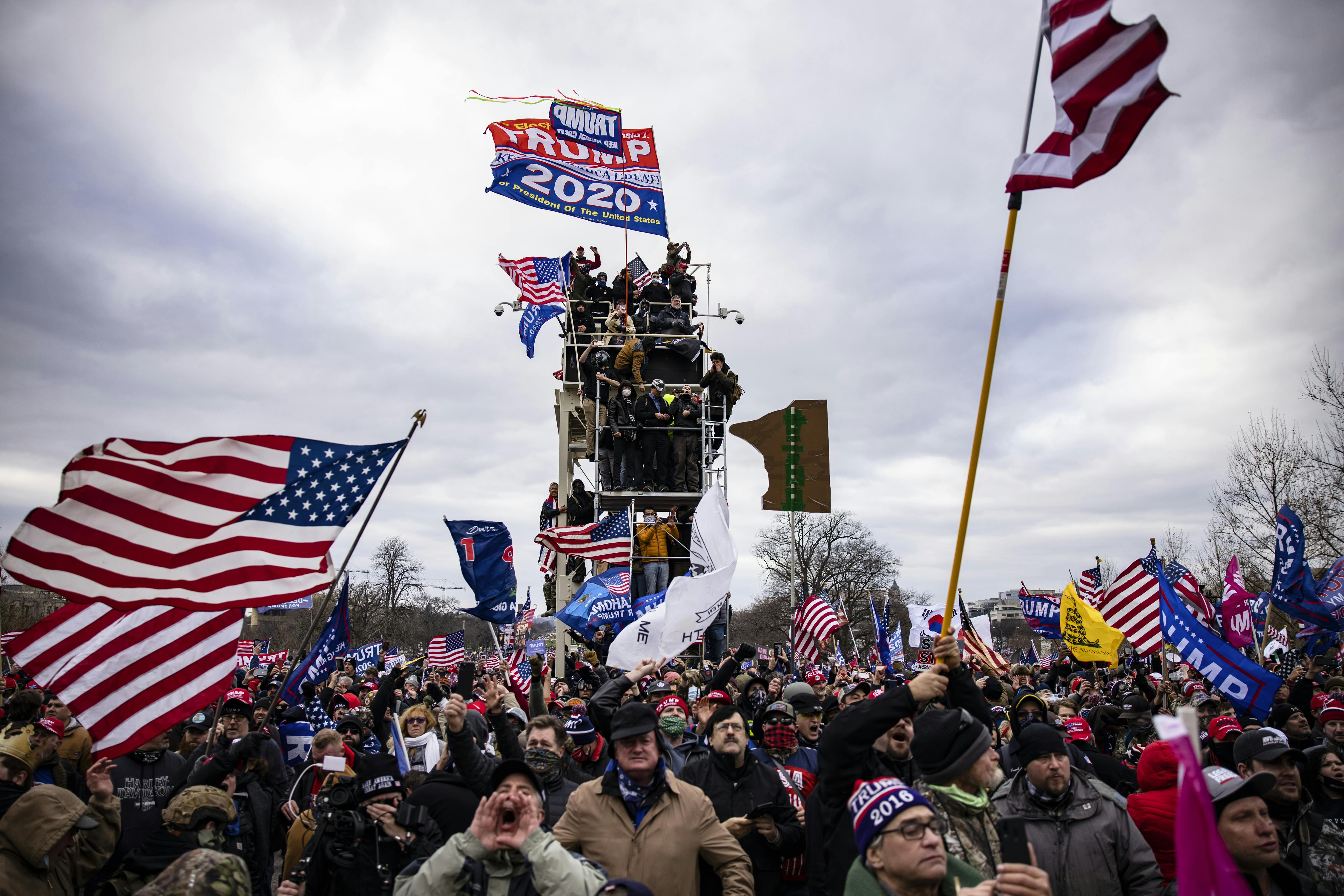 Pro-Trump supporters scale scaffolding and storm the Capitol.