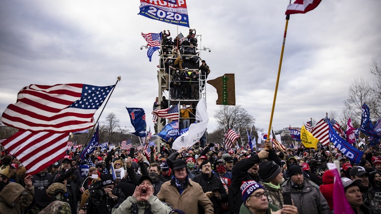 Pro-Trump supporters scale scaffolding and storm the Capitol.