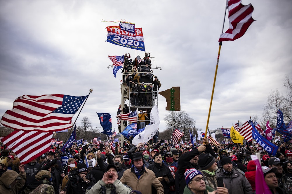 Pro-Trump supporters scale scaffolding and storm the Capitol.