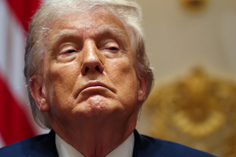 Donald Trump scowls while sitting in a Cabinet meeting