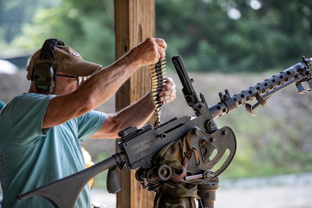 A man loads bullets into a machine gun during the Hillsborough County Republican Committee Sixth Annual Full-Auto Machine Gun Shoot in Litchfield, New Hampshire, on July 27, 2024.