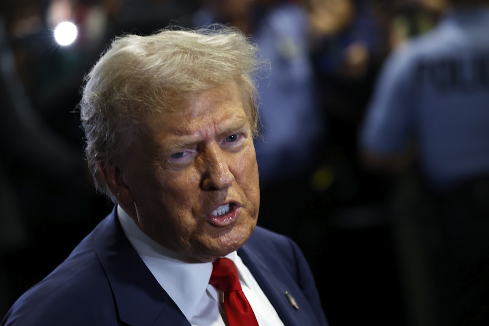 Donald Trump speaks to reporters in the spin room after debating Kamala Harris.