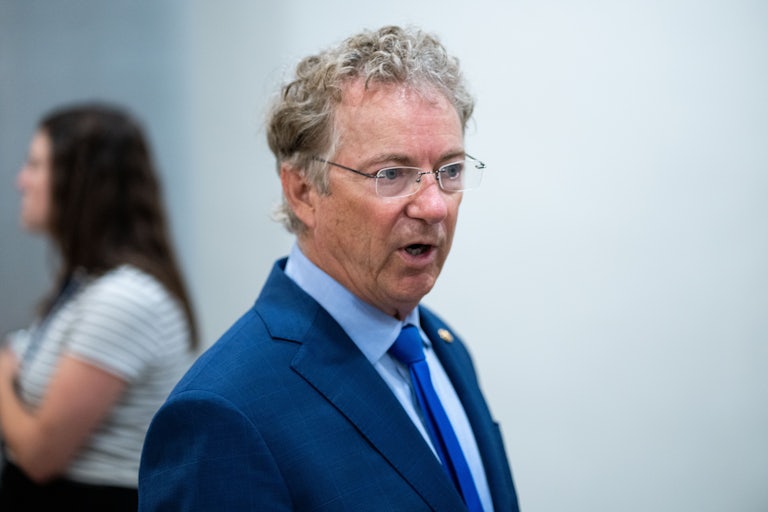 Senator Rand Paul speaks while walking in the U.S. Capitol
