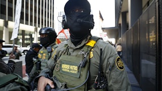 Two masked Border Patrol agents.