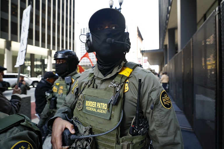 Two masked Border Patrol agents.