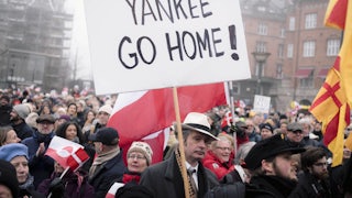 A person holds a sign that says, "Yankee go home!" during a protest in Copenhagen, Denmark, against Donald Trump's efforts to take over Greenland
