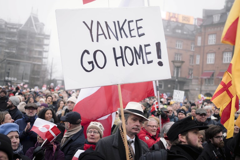 A person holds a sign that says, "Yankee go home!" during a protest in Copenhagen, Denmark, against Donald Trump's efforts to take over Greenland