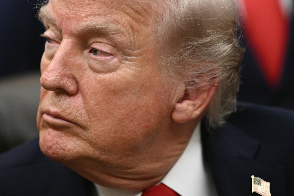 Donald Trump looks sideways, appearing tired