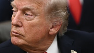 Donald Trump looks sideways, appearing tired