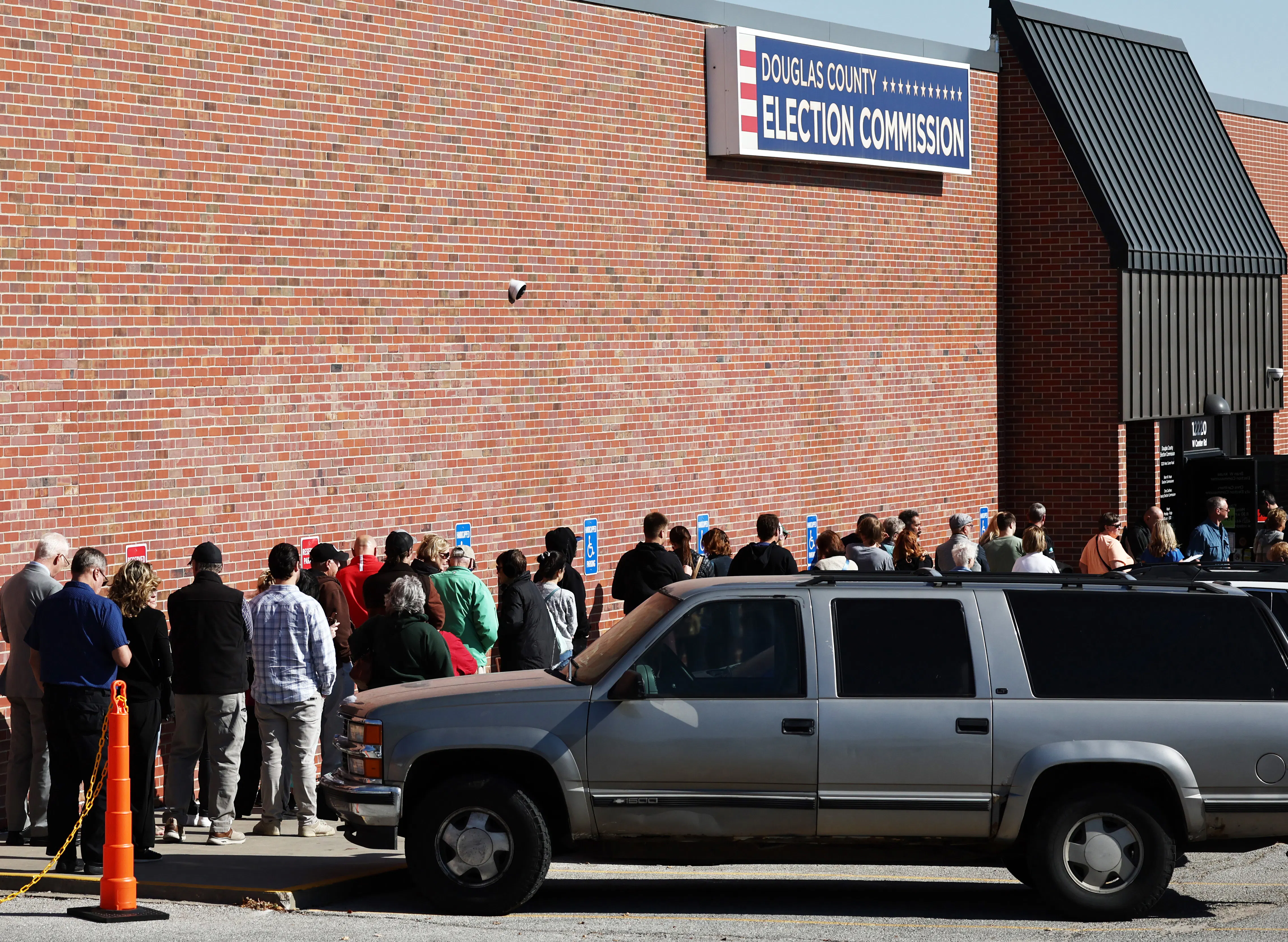 People wait in line to vote at the Douglas County Election Commission in Omaha, Nebraska
