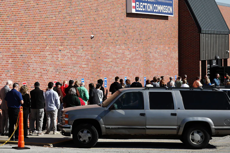 People wait in line to vote at the Douglas County Election Commission in Omaha, Nebraska