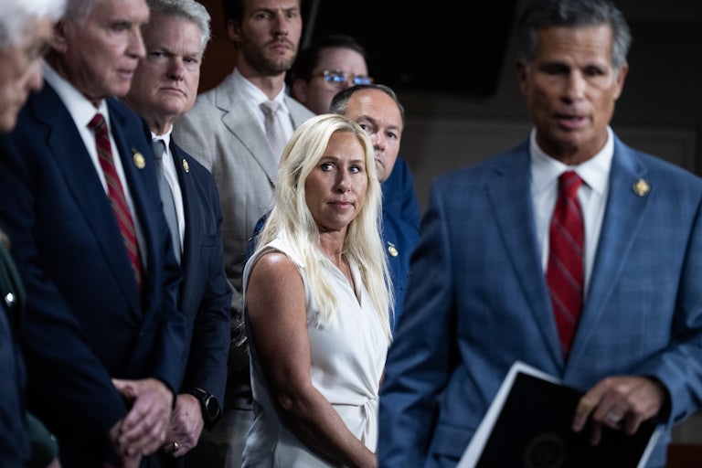 Representative Majorie Taylor Greene stands with other Republicans during a press conference