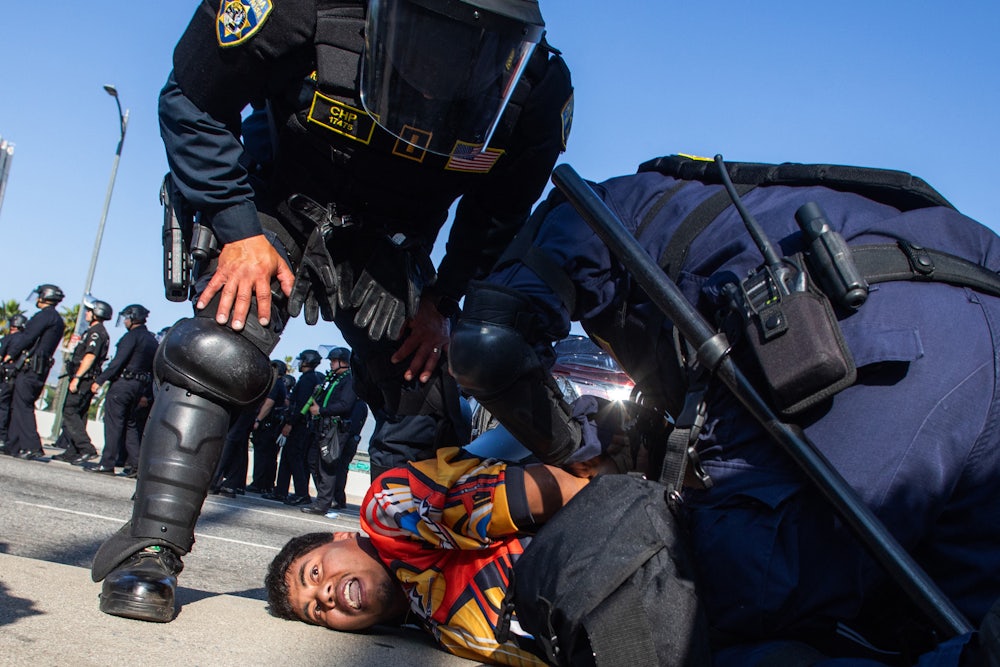 California Highway Patrol officers arrest a demonstrator in Los Angeles