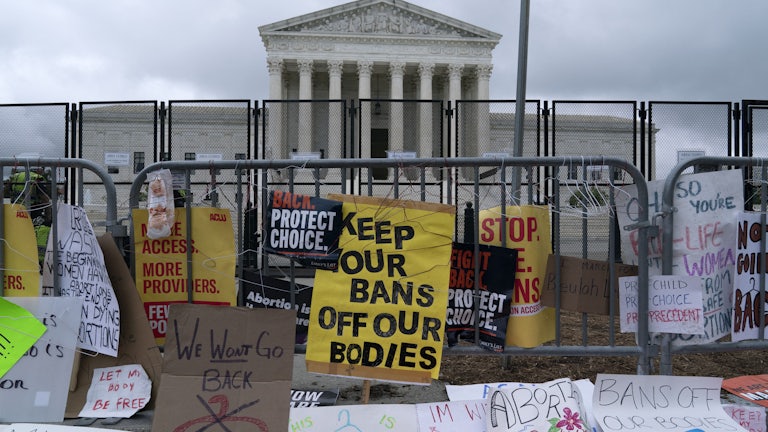Protest signs line the barricade around the U.S. Supreme Court.