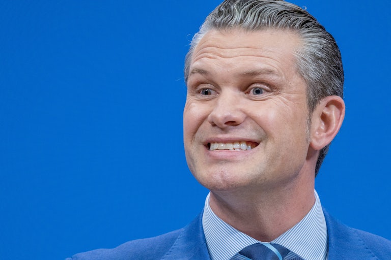 Defense Secretary Pete Hegseth smiles while speaking during a NATO press conference
