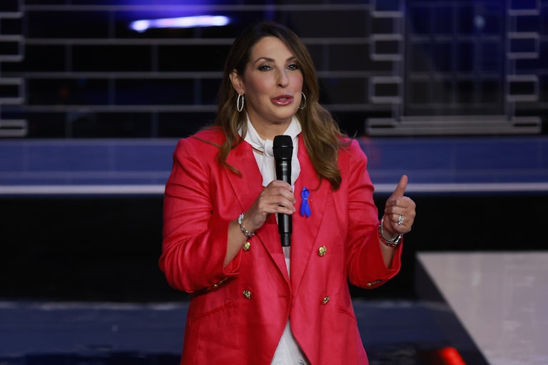 Ronna McDaniel speaks on a stage with a mic in her hand