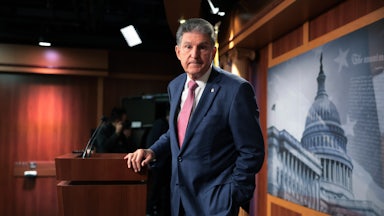Senator Joe Manchin shoots a glance offstage as he talks to reporters at the U.S. Capitol.