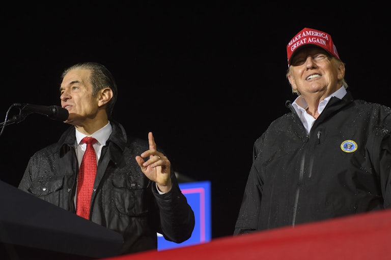 Donald Trump and Mehmet Oz stand together on stage