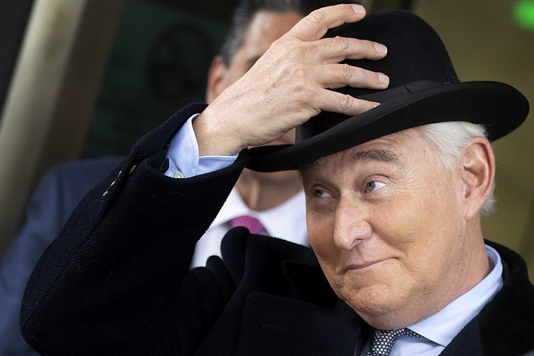Roger Stone touches his hat