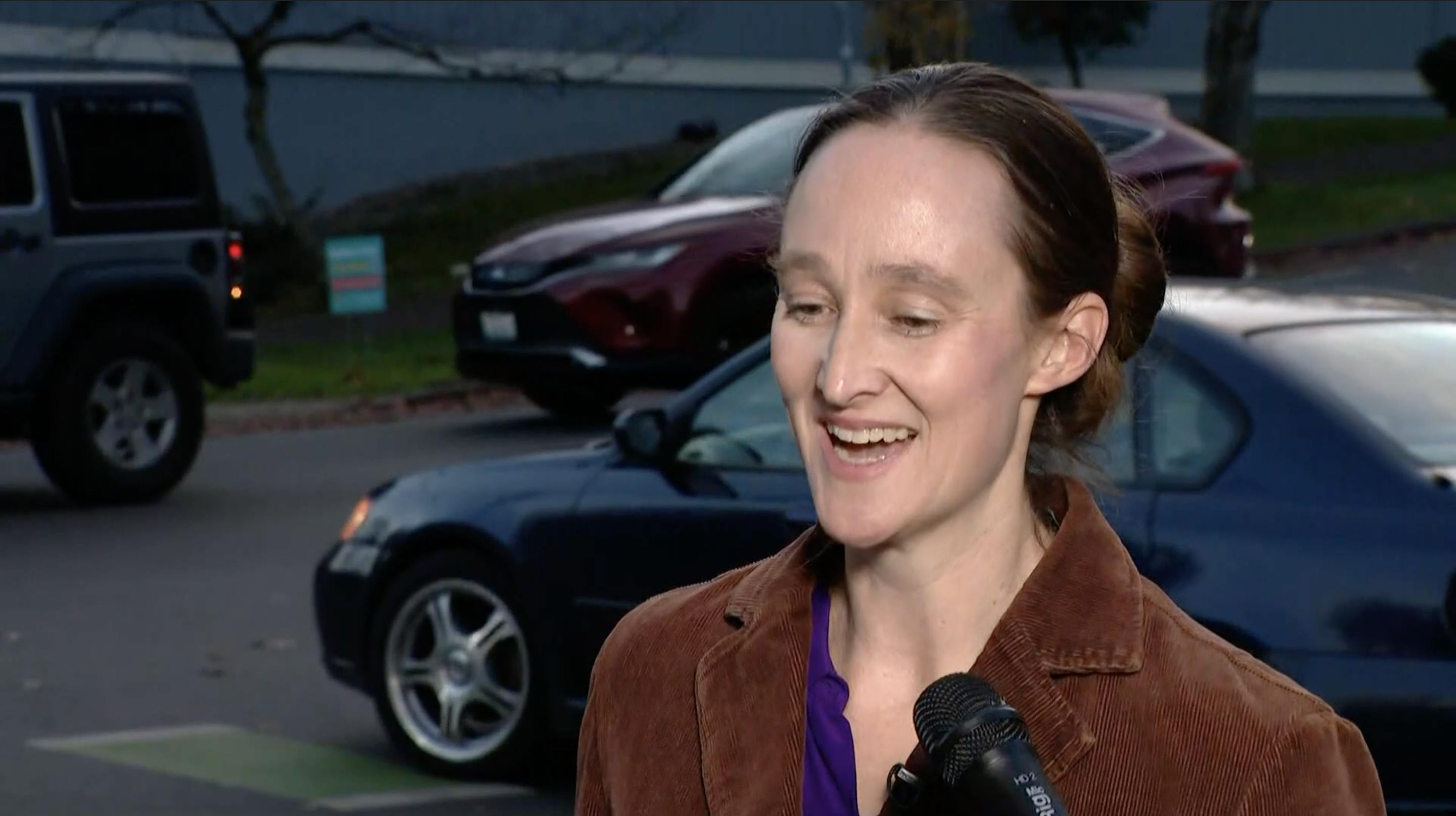 Katie Wilson smiles while being interviewed on the street.