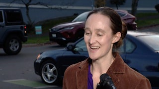 Katie Wilson smiles while being interviewed on the street.