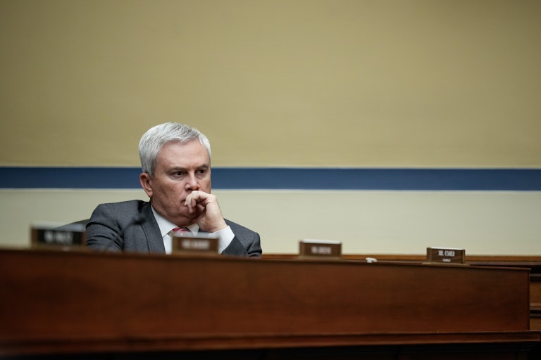 James Comer sits at the dais with his hand in front of his mouth