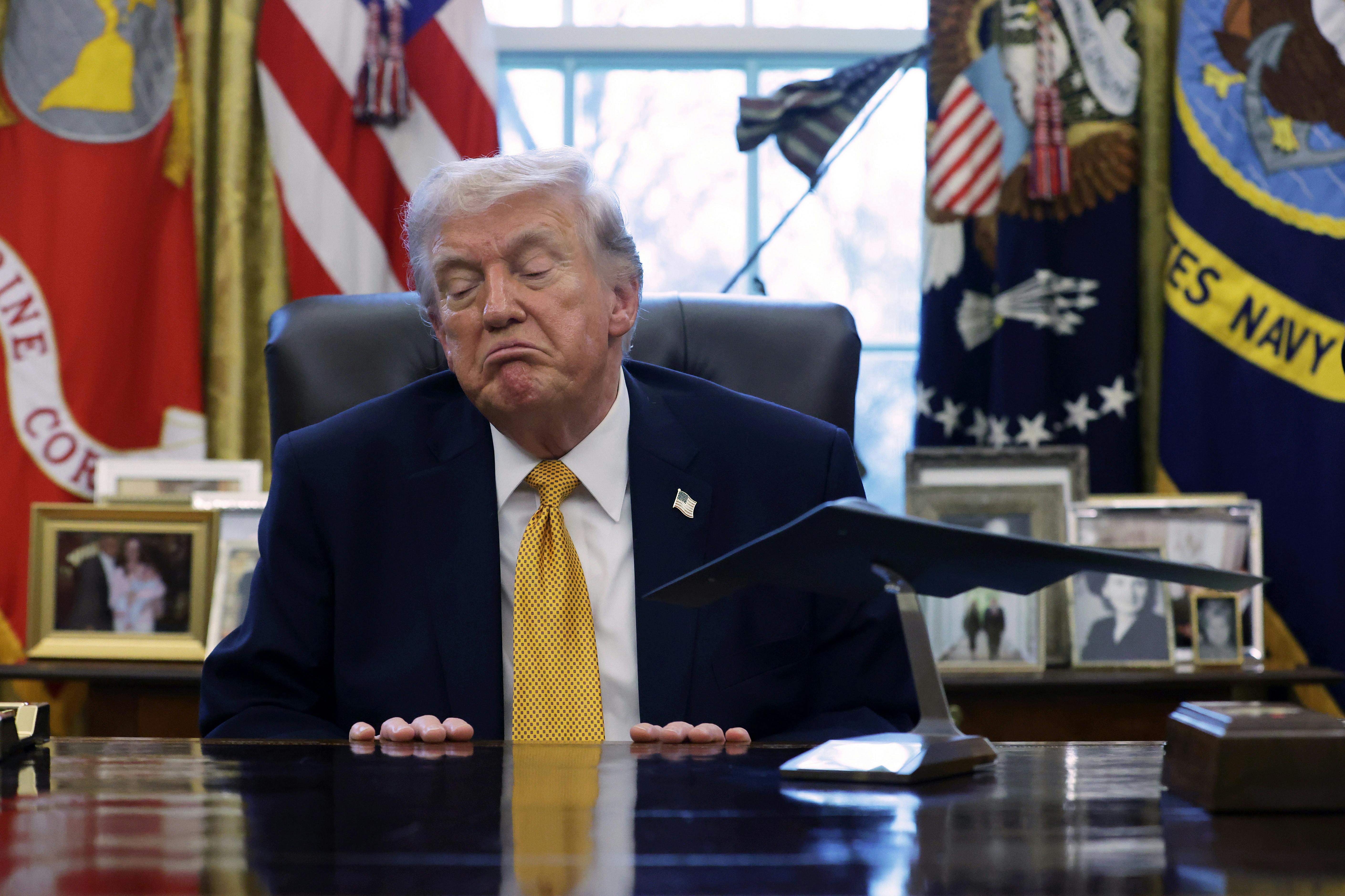 Donald Trump speaks to the media after signing a document during a White House signing ceremony in the Oval Office.