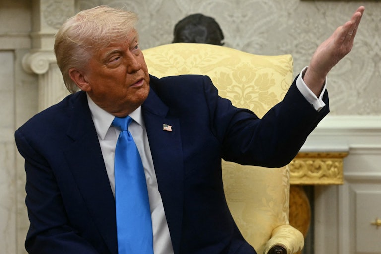 Donald Trump gestures while speaking in the Oval Office
