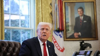 Donald Trump speaks to the press before signing an executive order in the Oval Office.