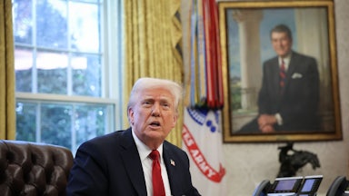 Donald Trump speaks to the press before signing an executive order in the Oval Office.