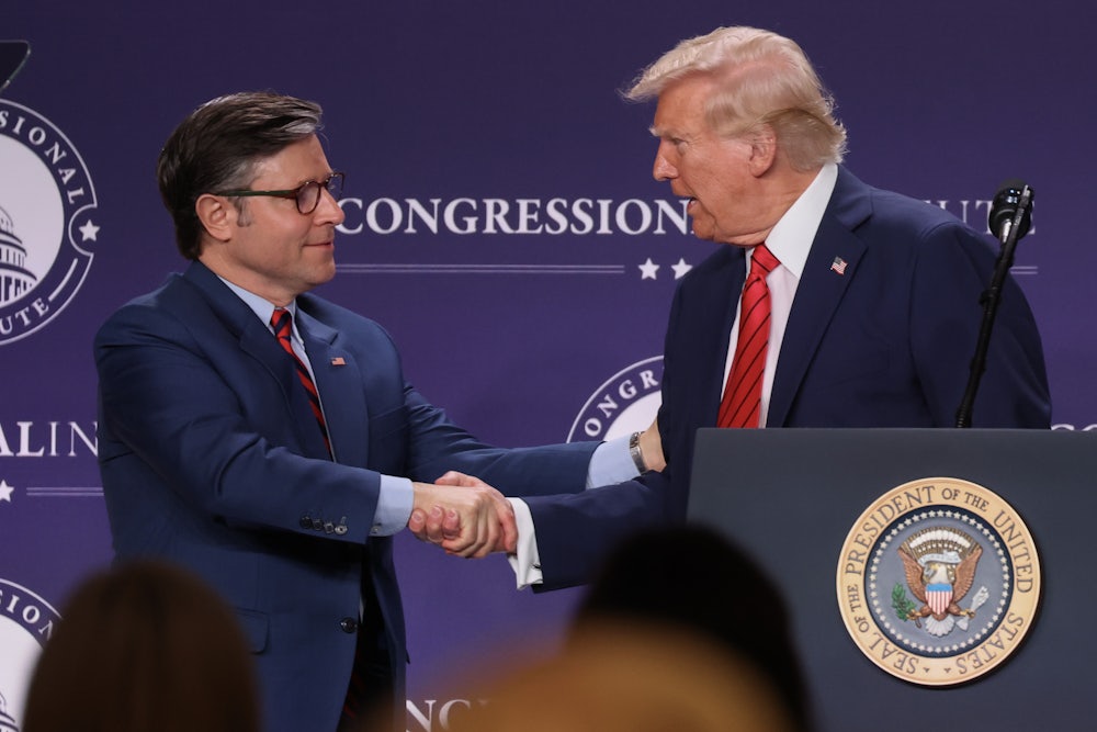 Donald Trump shakes hands with House Speaker Mike Johnson.