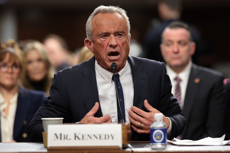Robert F. Kennedy gestures at himself while speaking during his Senate confirmation hearing