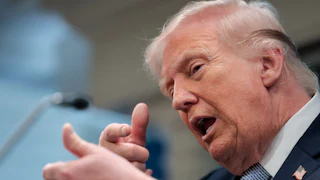 President Donald Trump speaks and makes a hand gesture as if he's about to shoot someone with a sniper.