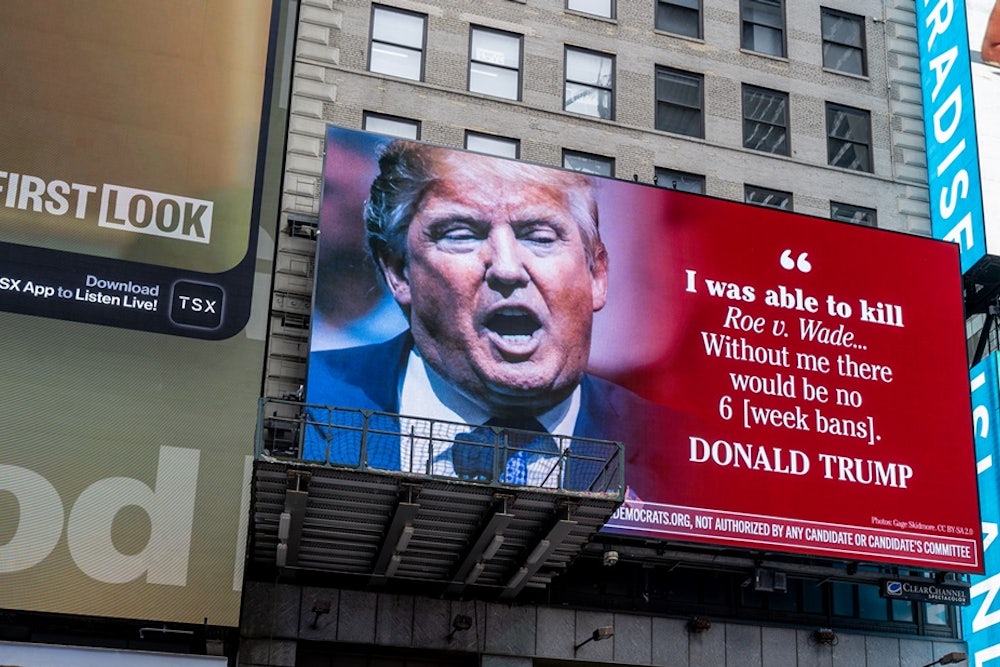 The Democratic National Committee's billboard in Times Square highlighting Donald Trump and other GOP hopefuls' support for a national abortion ban.