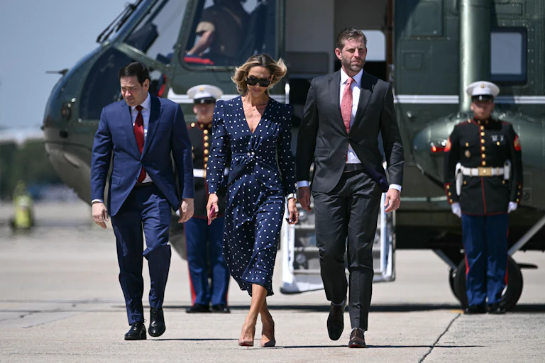 Lara and Eric Trump walk to board Air Force One