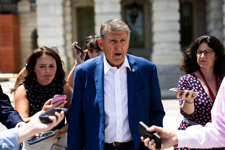 Joe Manchin speaks while supporters surround him outside the Capitol