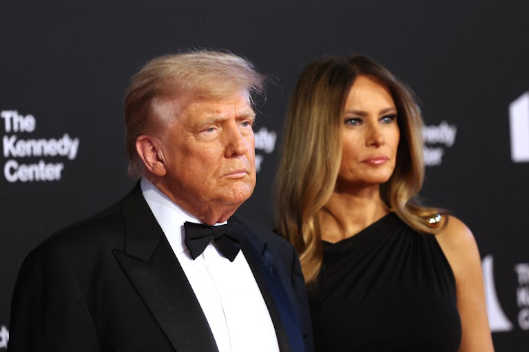 Donald Trump and Melania Trump dressed up pose in front of a Kennedy Center backdrop