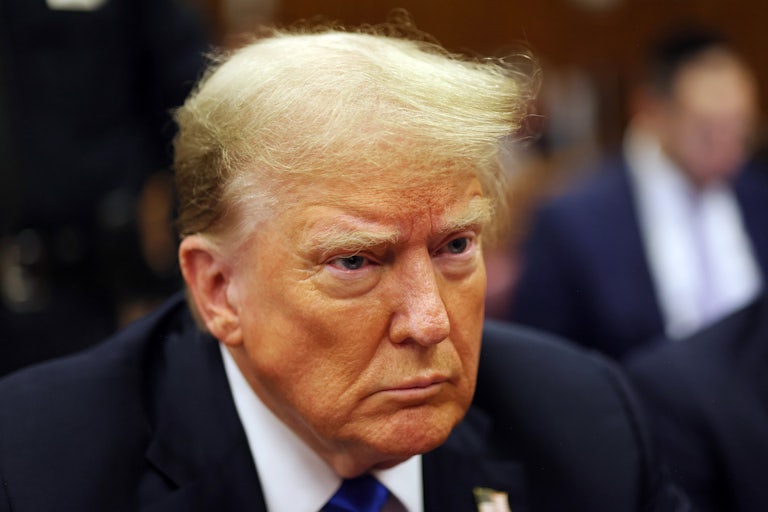 Donald Trump sits in a courtroom