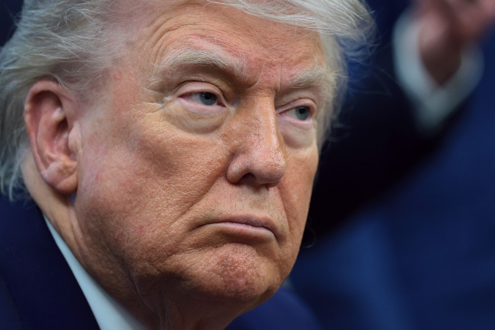 A close up of a scowling Donald Trump