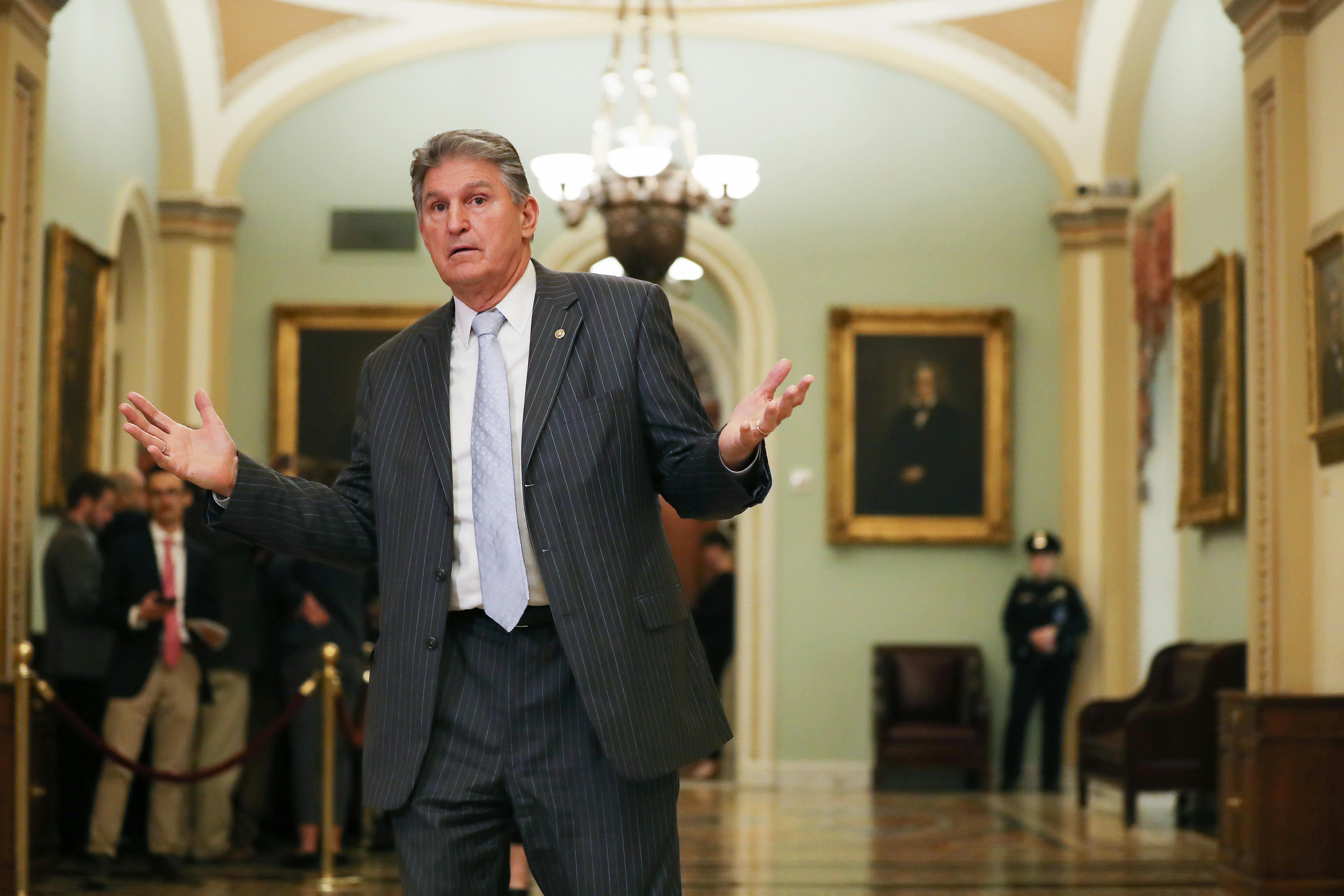 West Virginia Democrat Joe Manchin gestures outside the Senate chamber.