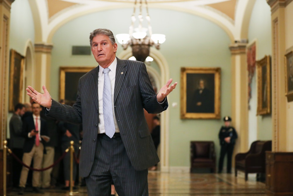 West Virginia Democrat Joe Manchin gestures outside the Senate chamber.