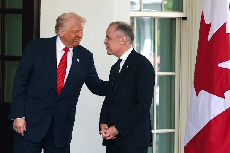 Donald Trump puts his hand on Canadian Prime Minister Mark Carney’s arm while they stand outside the White House